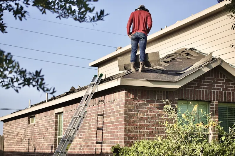 Professional roofer working on a residential roof in Brookshire